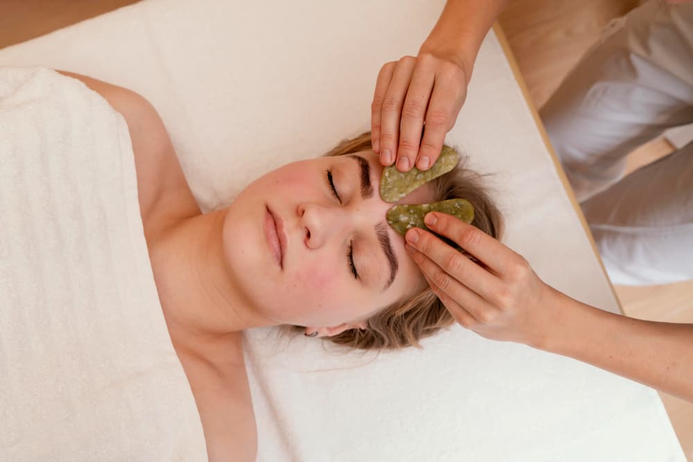 Practitioner administering Nasya karma in a calm clinical setting.