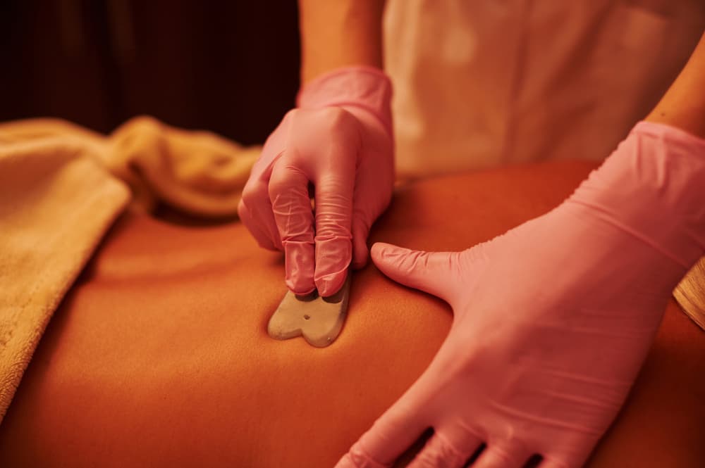 Practitioner performing Kshar Sutra thread placement under local anaesthesia.