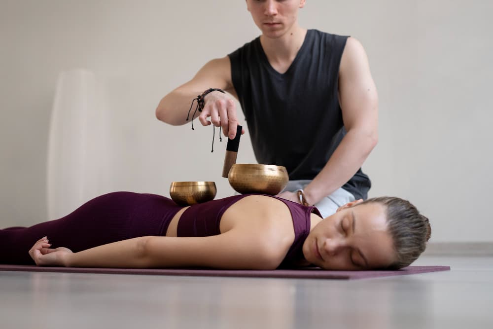 Therapist preparing medicated oil for ear and nasal Ayurvedic therapy.