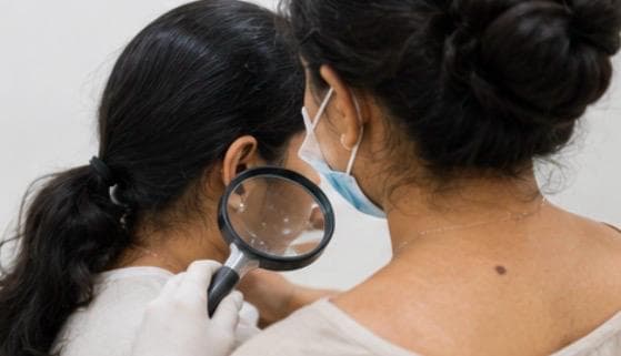 Close magnified examination of the skin during an Ayurvedic dermatology assessment.