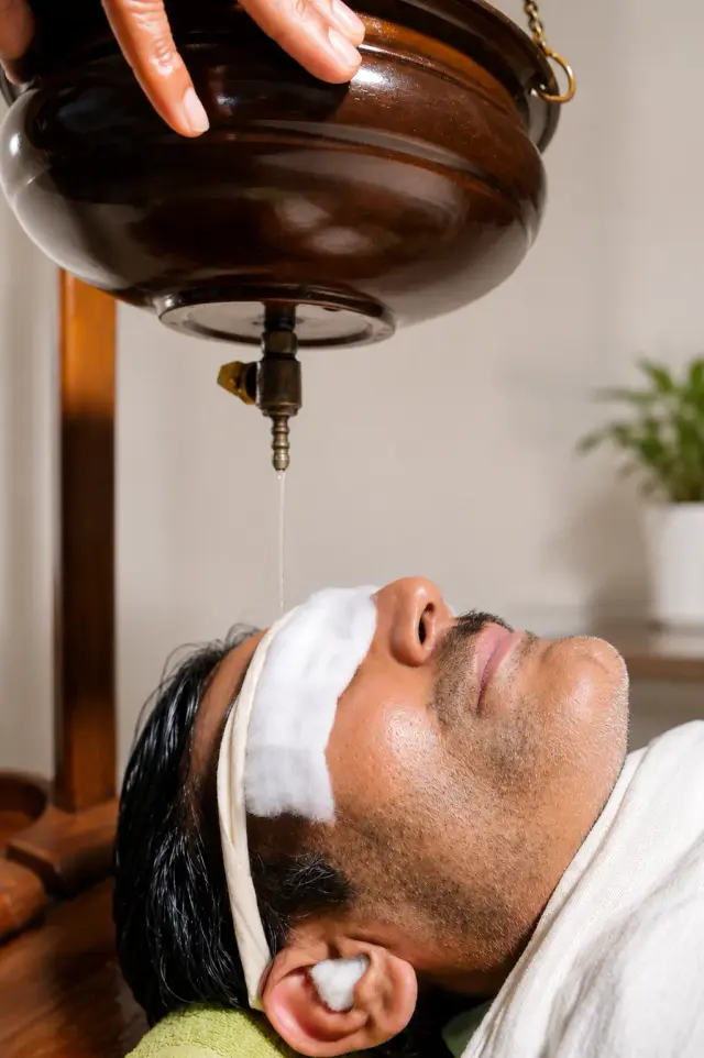 Panchakarma physician reviewing a patient's detox consultation response.