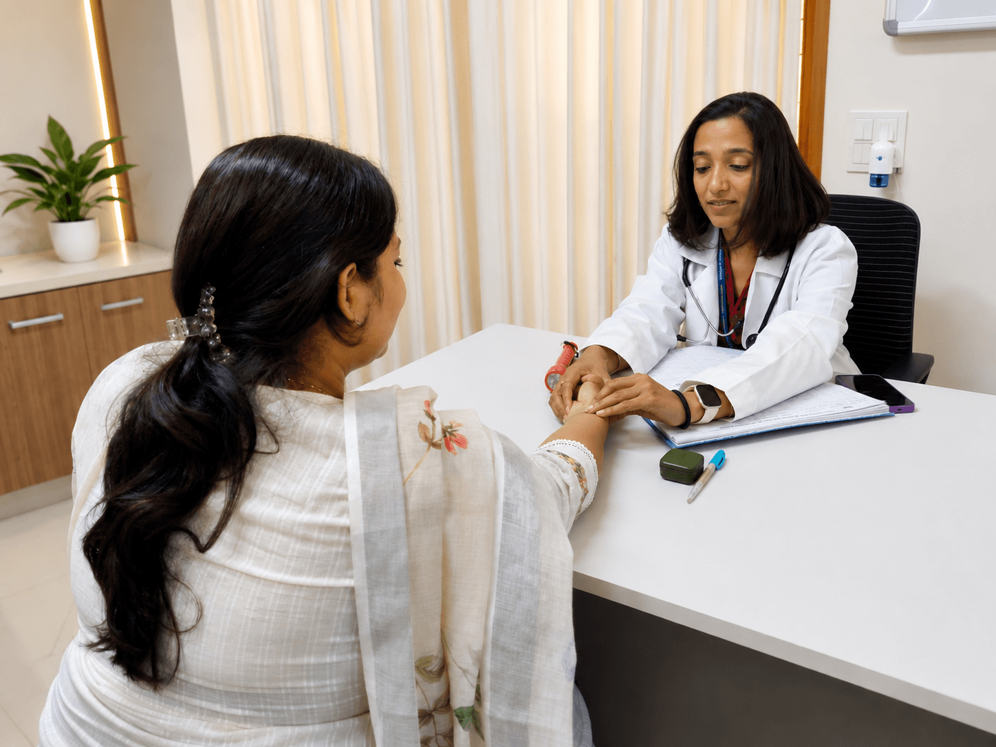 Ayurvedic gynaecologist consulting a woman during a Prasuti Evum Stri Rog appointment.