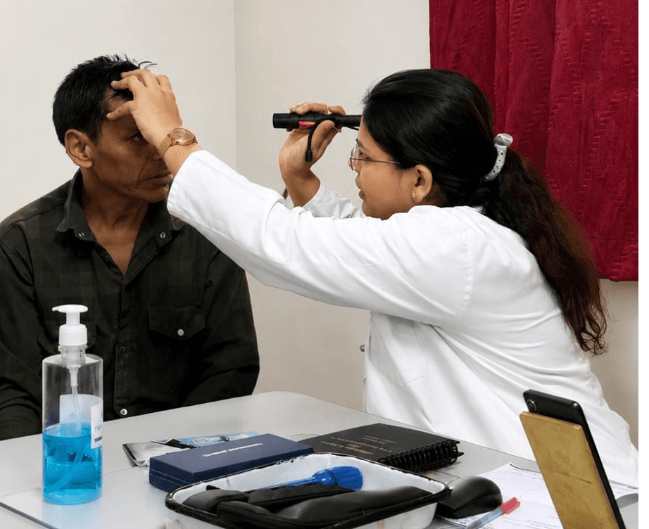 Ayurvedic ophthalmologist performing Netra Tarpan — a medicated ghee eye nourishment procedure.