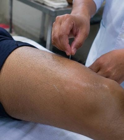 Foot acupressure being applied by a therapist.