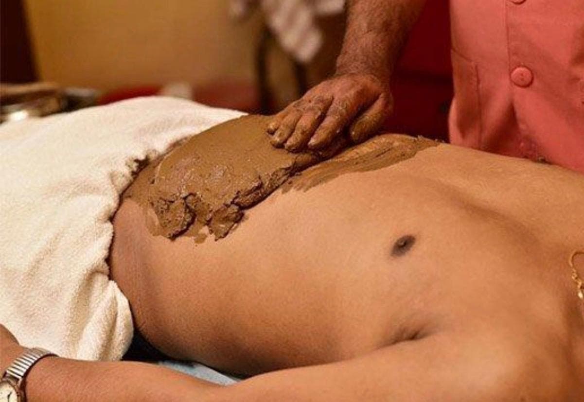 Abdominal mud pack applied to a patient in the naturopathy wing.
