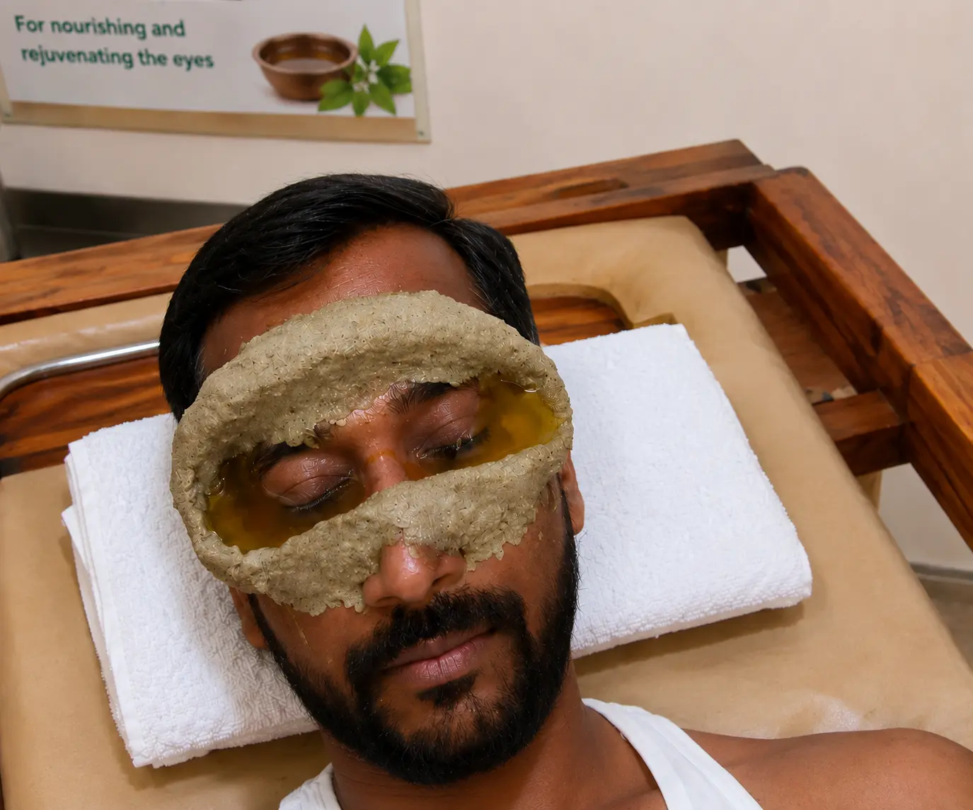 Dough rings sealed around both eyes and being filled before Netra Tarpana.