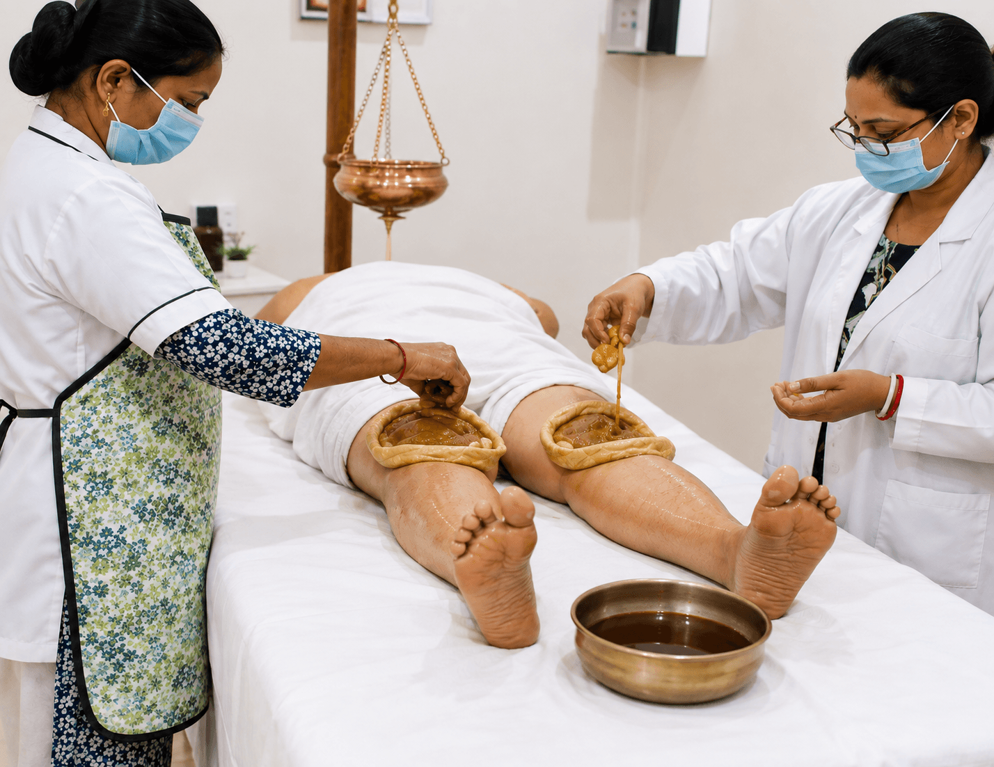 Warm herbal pack placed over a patient's lower back.