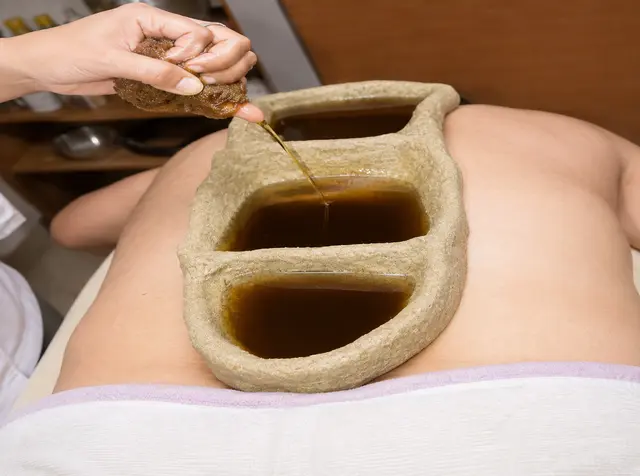 Dough well built over a patient's lower back and topped up with warm medicated oil for Kati Basti.