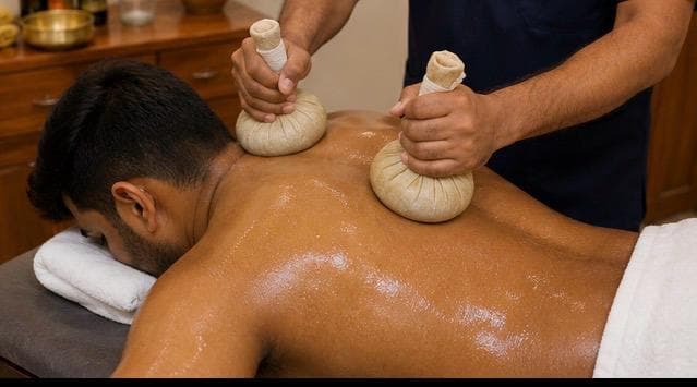 Close view of cloth-tied herbal bundles being worked over the shoulders and upper back.